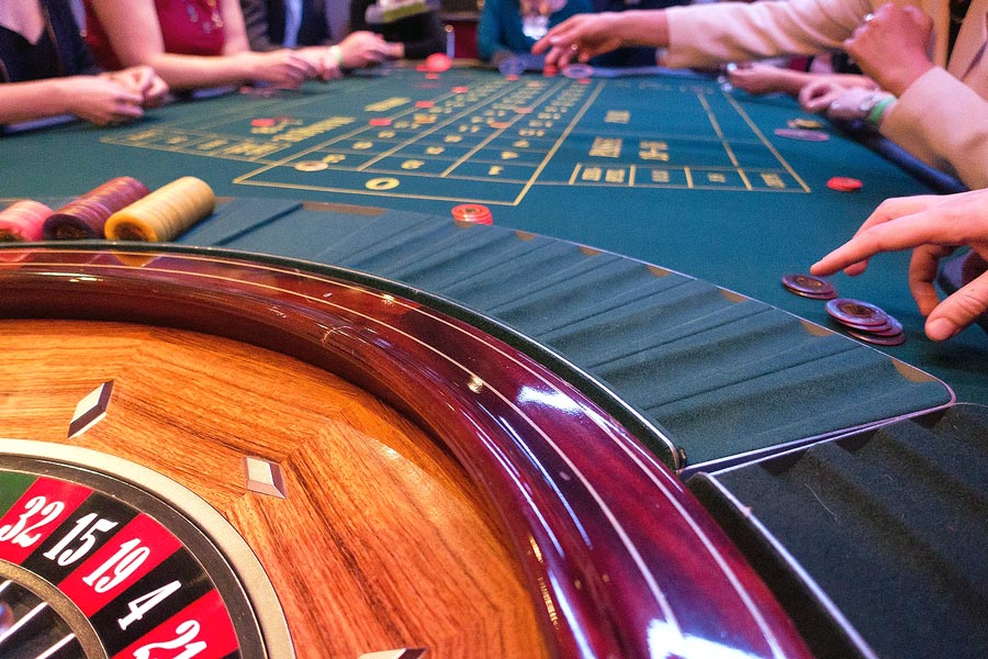 People sitting down, playing French Roulette